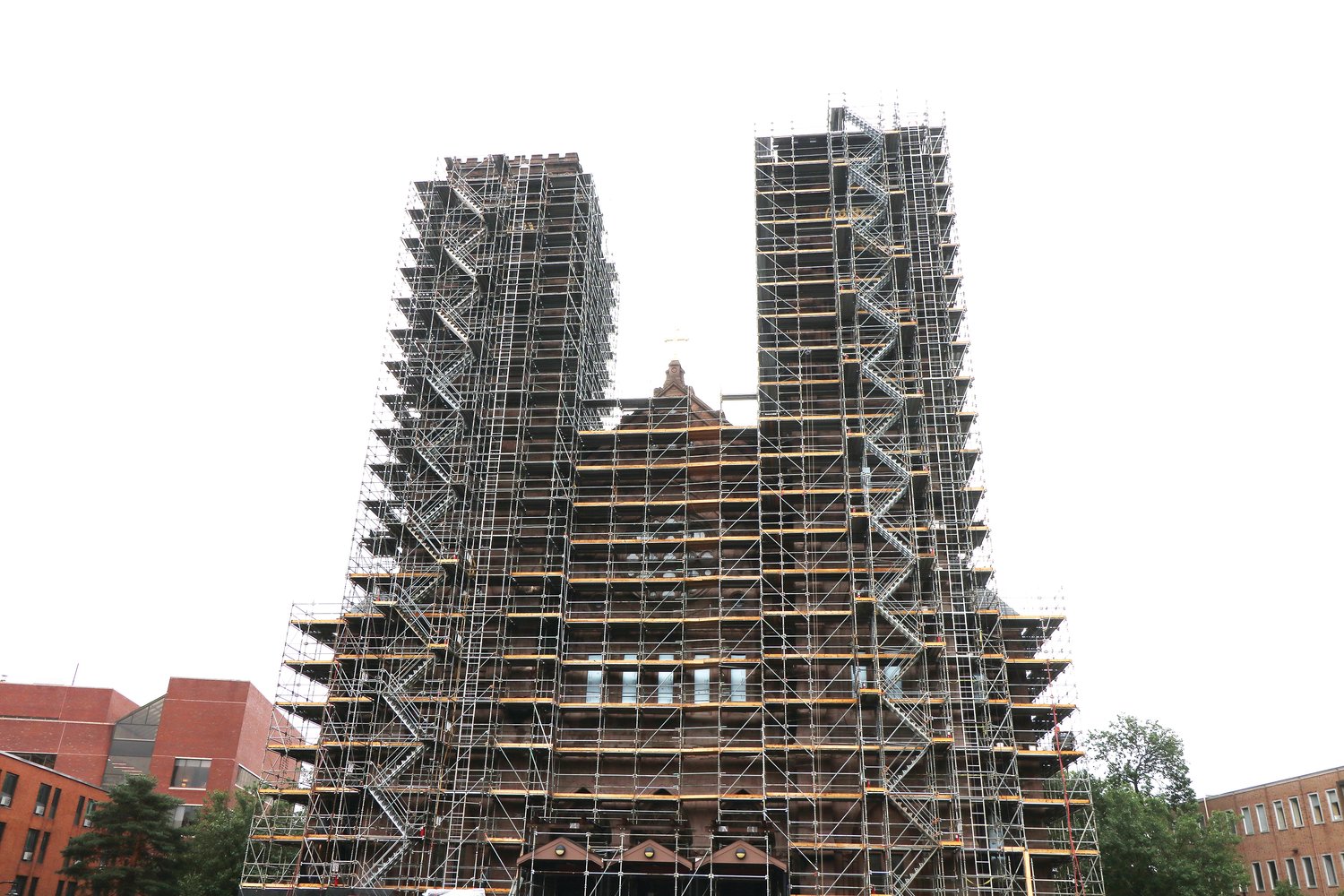 Scaffolding extends 20 stories into the air, protecting the workers who will spend the next seven months repairing erosion in the towers of the Cathedral of SS. Peter and Paul, which was consecrated in 1889 and serves as the seat of the Diocese of Providence.
